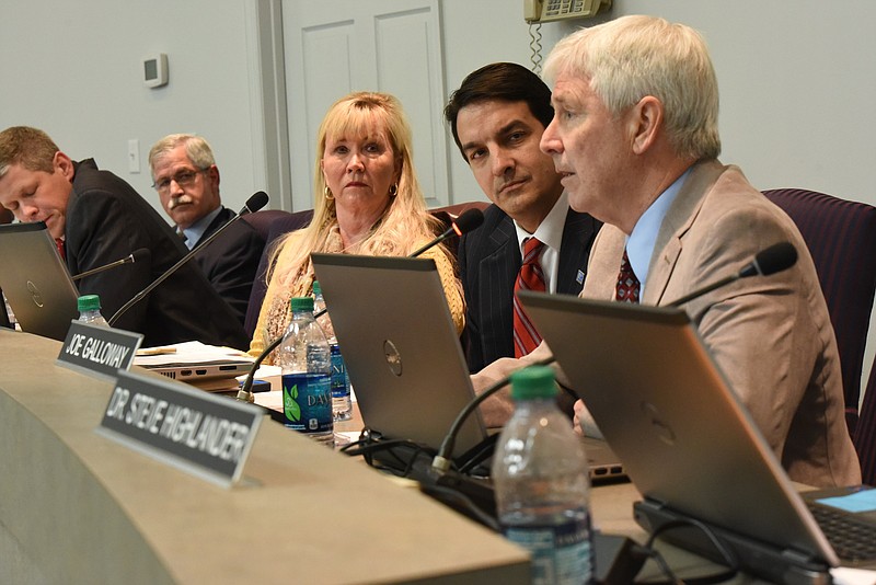 Staff photo by Tim Barber Hamilton County School Board member Joe Galloway, right, makes a positive statement Thursday night about Superintendent Rick Smith, second from left, as the board discusses a buyout for Smith. From left are, Dr. Jonathan Welch, Smith, Donna Horn, Dr. Greg Martin and Galloway.