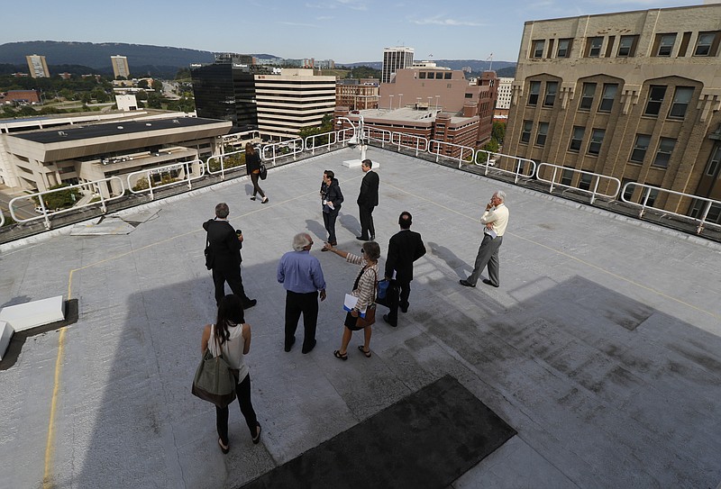 Officials are led on a tour of the Edney Building which will soon become the new hub of the Innovation District housing CoLab and the Enterprise Center.