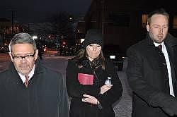 Jordan Graham, center, is flanked by defense attorneys Michael Donahoe, left, and Andy Nelson, as she leaves court in Missoula, Mont., in this Dec. 10, 2013, file photo.