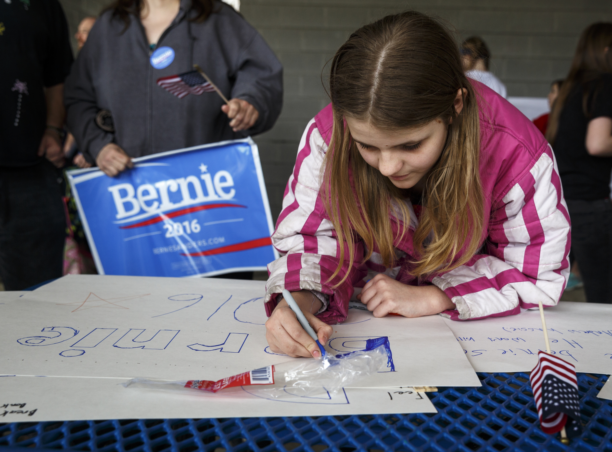 Chloe Grauel makes her own campaign sign during a rally for Democratic presidential primary candidate Bernie Sanders held at Renaissance Park on Saturday, Feb. 20, 2016, in Chattanooga, Tenn. Supporters then marched across the Market Street Bridge to show their support.