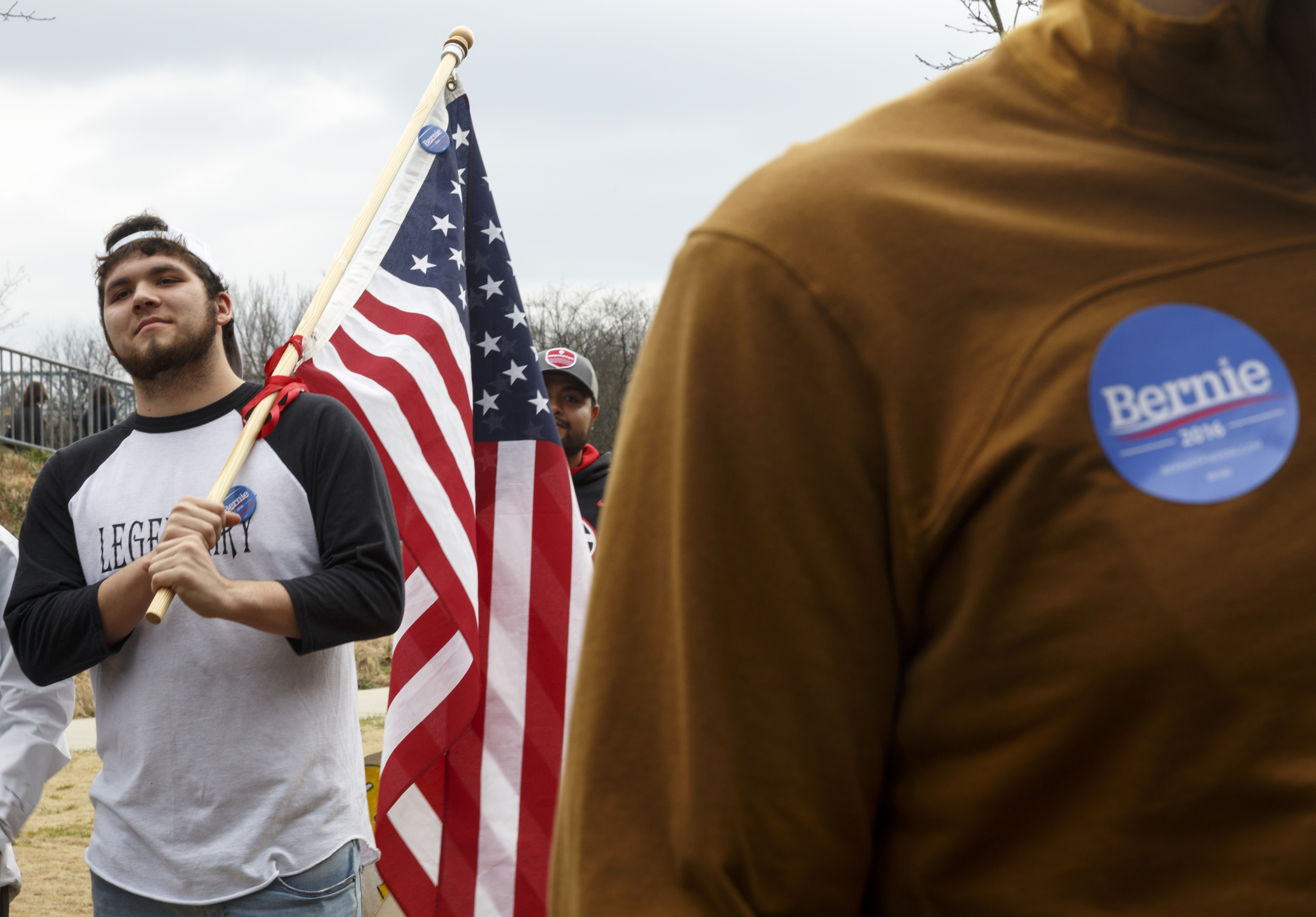 Andy Besh holds an American flag during a rally for Democratic presidential primary candidate Bernie Sanders held at Renaissance Park on Saturday, Feb. 20, 2016, in Chattanooga, Tenn. Supporters then marched across the Market Street Bridge to show their support.