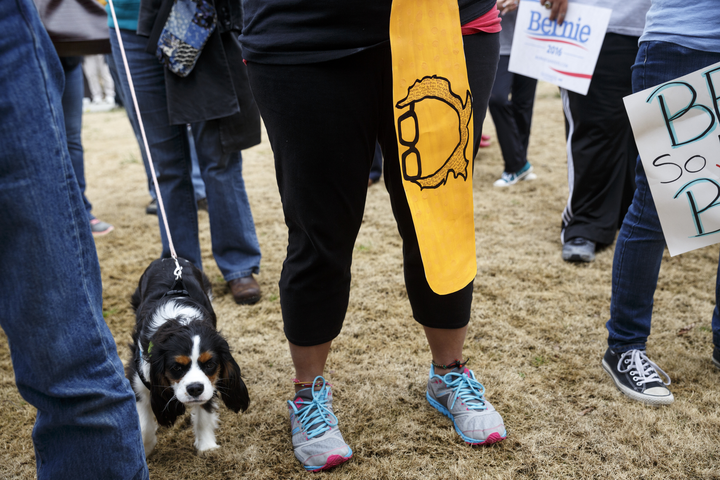 A supporter holds a sign printed with Sanders's glasses and hair during a rally for Democratic presidential primary candidate Bernie Sanders held at Renaissance Park on Saturday, Feb. 20, 2016, in Chattanooga, Tenn. Supporters then marched across the Market Street Bridge to show their support.