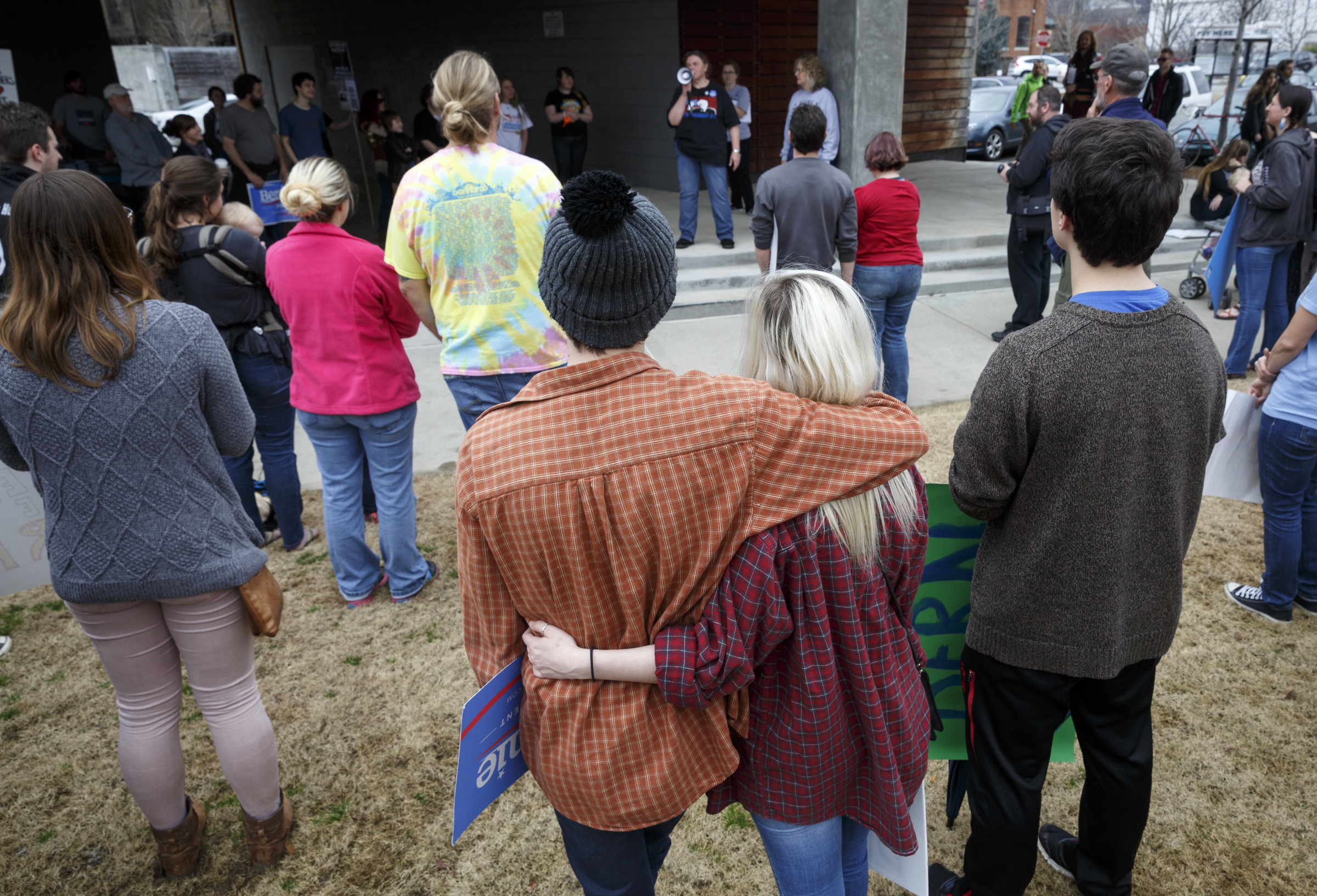 Jake Van Valkenburg, left, and Reese Williams embrace while listening to a speaker during a rally for Democratic presidential primary candidate Bernie Sanders held at Renaissance Park on Saturday, Feb. 20, 2016, in Chattanooga, Tenn. Supporters then marched across the Market Street Bridge to show their support.