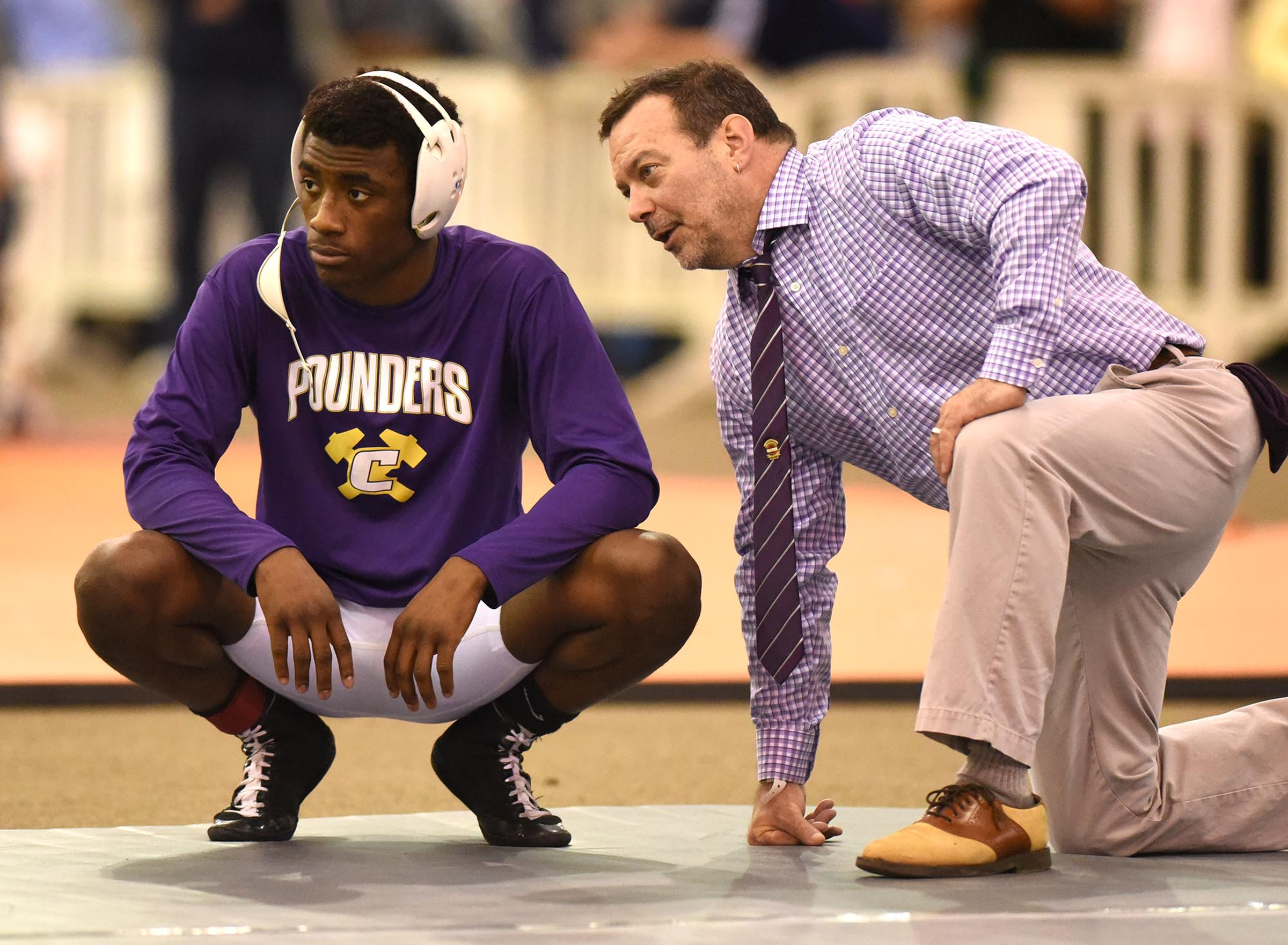 Central head coach Johnny Lennon (right) talks to Alonso Heyward before Heyward's 152 point match. Heyward won the state title. The finals of the TSSAA State Wrestlings Championships were held at the Williamson Agricultural Center in Franklin, Tn. on February 20, 2016.