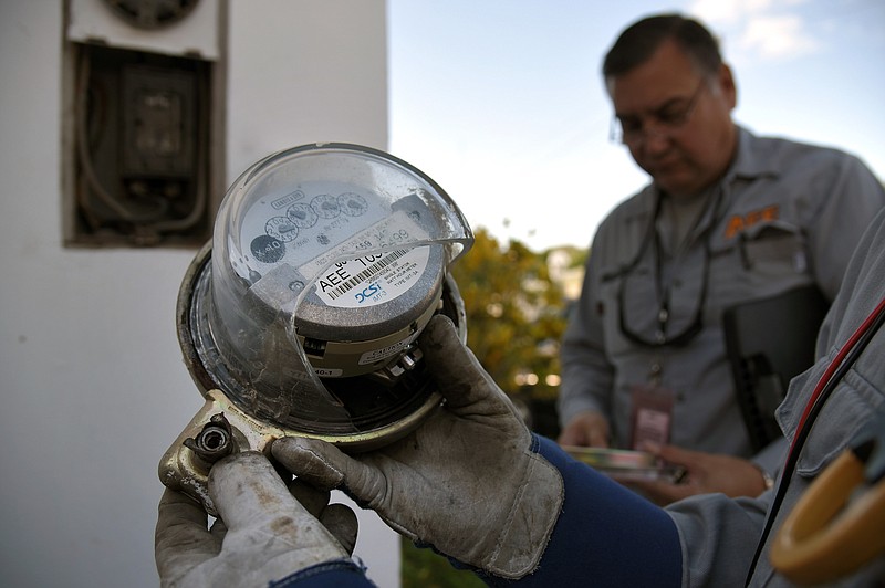 
              In this Feb. 4, 2016 photo, a worker from the Energy Theft Control Unit with Puerto Rico's Electric Power Authority holds an electric meter with busted glass during an inspection in Carolina, Puerto Rico. The workers said the counter showed a common sign of tampering. The island is cracking down on people who steal power, cheat on their taxes or don't pay other bills as the U.S. island territory struggles to raise money to make bond payments. (AP Photo/Carlos Giusti)
            
