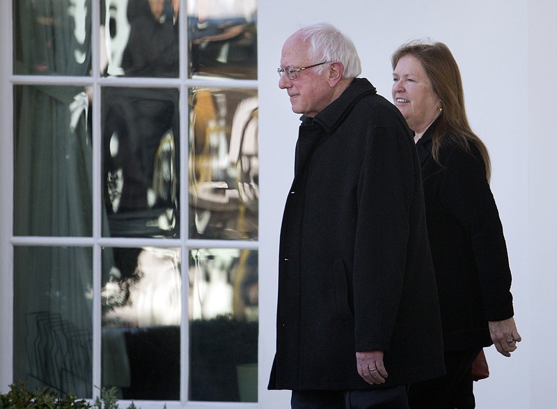 Democratic presidential candidate Sen. Bernie Sanders, I-Vt., left, walks with his wife, Jane Sanders, after a recent meeting with President Obama at the White House. With his grandiose spending plans, Sanders may be taking a page out of the book his wife wrote when she was president of Burlington College in Vermont.
