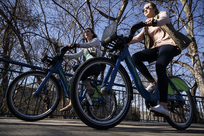 Cyclists ride on the Tennessee Riverwalk on Friday, Feb. 19, 2016, in Chattanooga, Tenn.