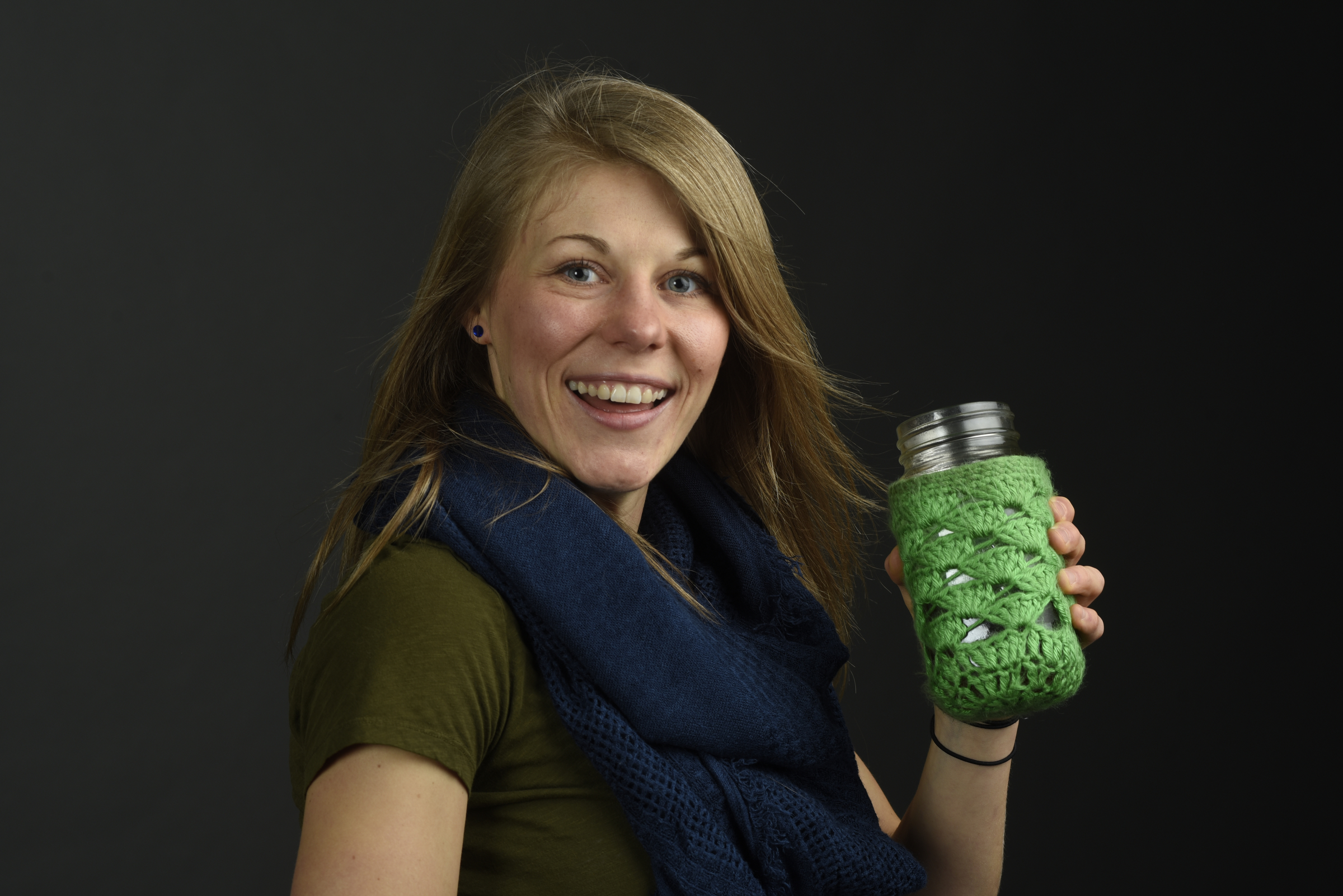 Tiffany Malapanes, founder of Positiffitea, drinks her tea from a canning jar cushioned in a crocheted sleeve.