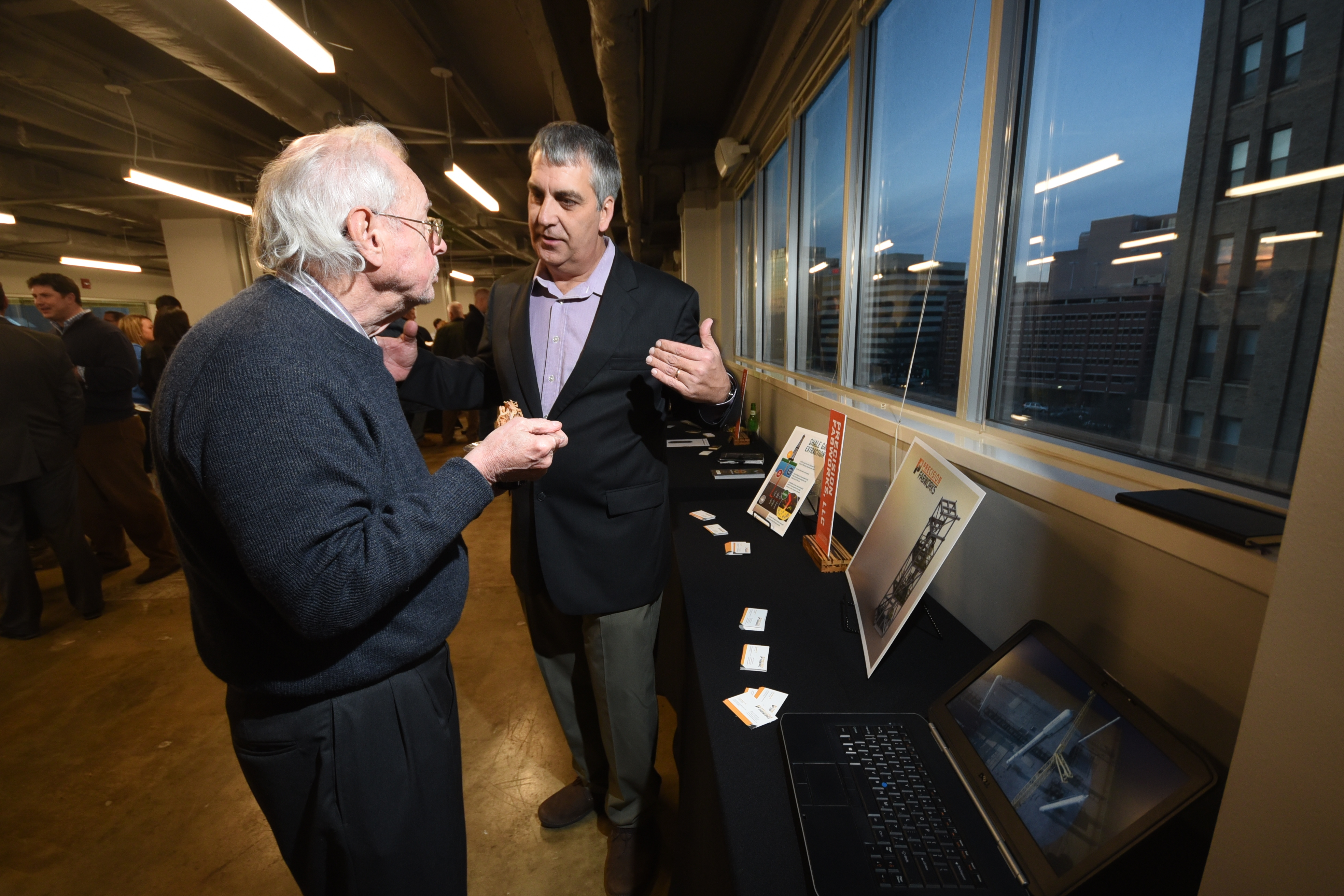 Chuck Mason, right, talks to Olin Ivey about his Precision Fabworks company Wednesday at the Company Lab's Pitch Night.