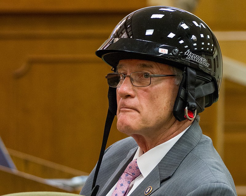 State Sen. Todd Gardenhire, R-Chattanooga, wears a motorcycle helmet during a 2013 committee hearing on repealing the state's helmet law.