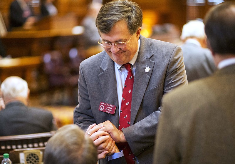 Georgia State Rep. Rick Jasperse, R-Jasper, is congratulated after his bill allowing gun license-holders to carry concealed handguns on Georgia's public college campuses passes a vote on the House floor Monday, Feb. 22, 2016, in Atlanta.