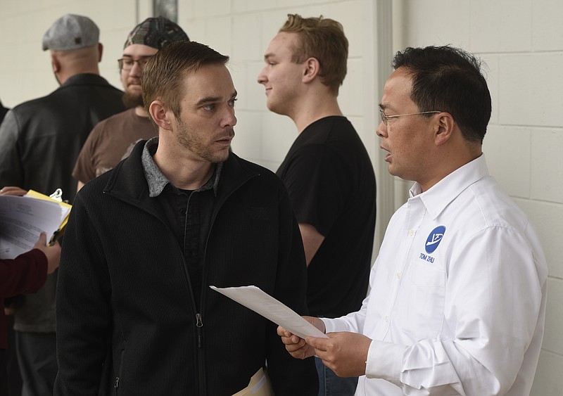 Project manager Tom Zhu, right, talks with Matthew Williams during a job fair for Yanfeng Automotive Interiors held on Tuesday, Feb. 23, 2016, in Chattanooga, Tenn., at the Wacker Institute at Chattanooga State Community College. Yanfeng, a Volkswagen supplier, is building a new manufacturing plant in Chattanooga. 