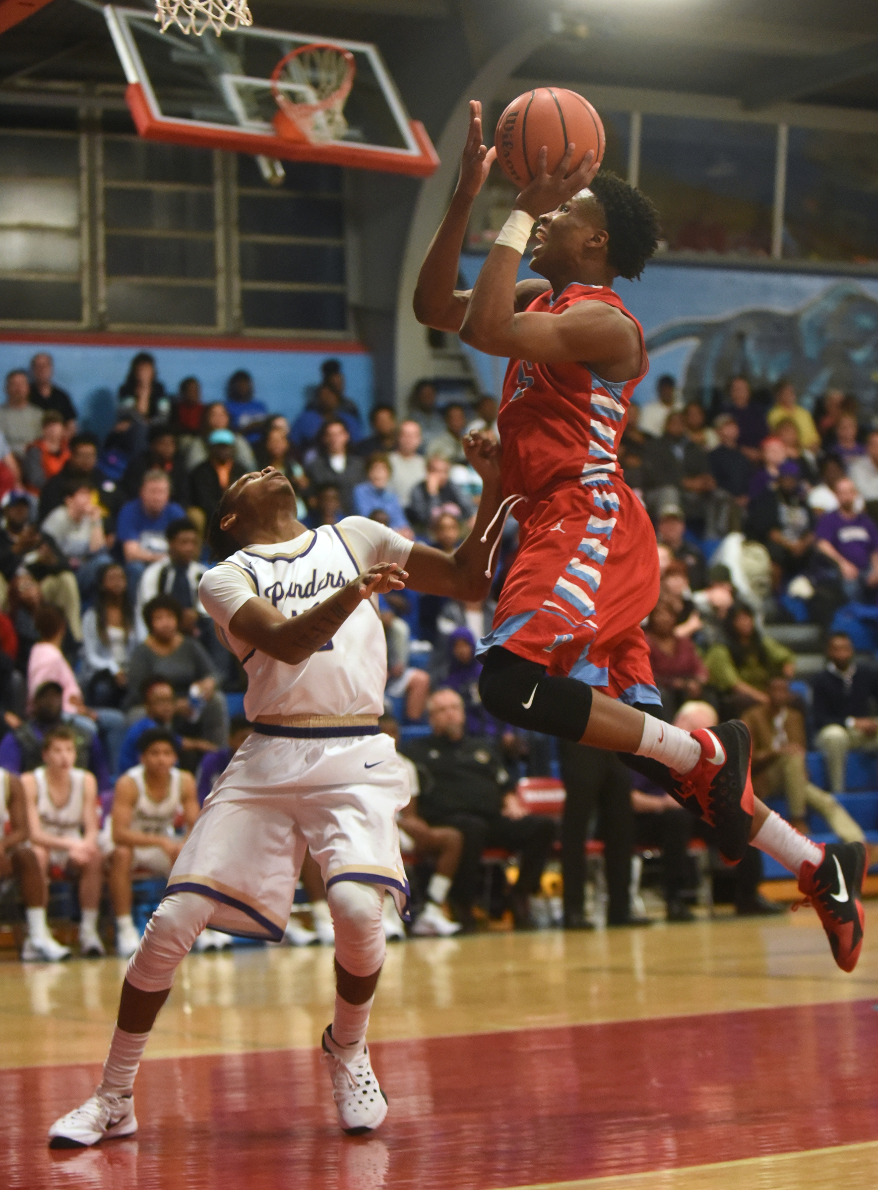 Brainerd's Dajuonta Ross takes a shot over Central's Rodney Benford Tuesday, February 23, 2016 at Brainerd High School.