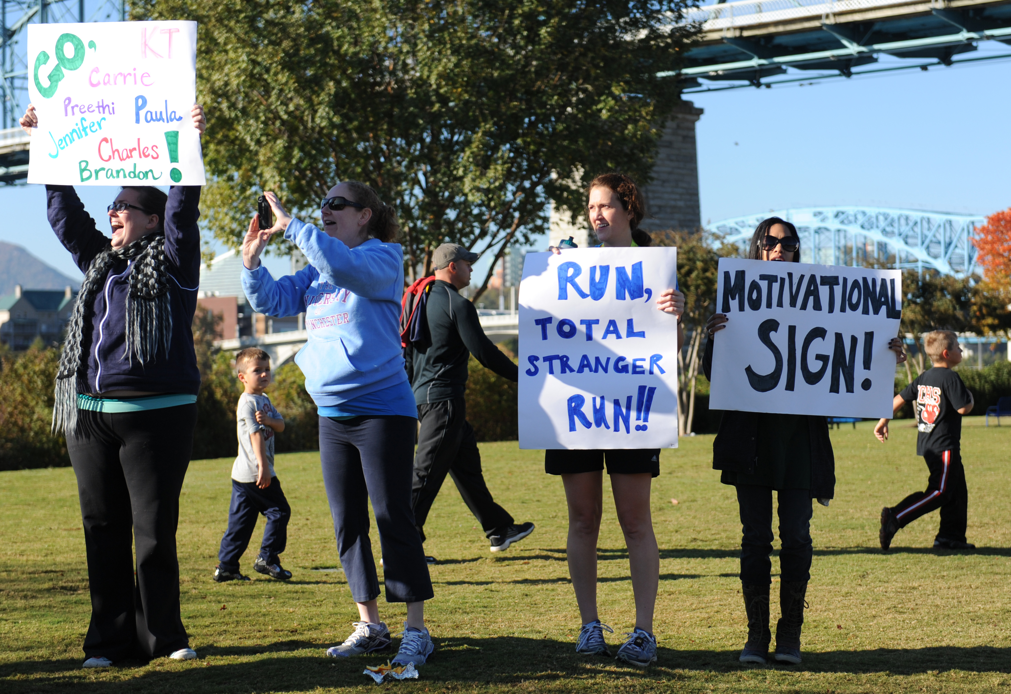 Susan Burran, Marina Smitherman, Carrie Anderson and Kara Rainey, from left, motivate runners as they make their way to the finish line during a previous 7 Bridges Marathon.