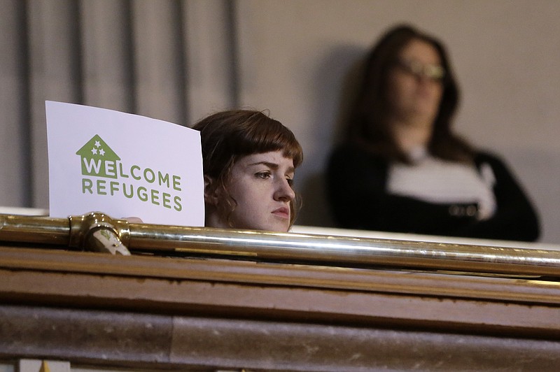 A demonstrator opposed to immigration restrictions watches from the gallery in the Senate Chamber on Monday, Feb. 22, 2016, in Nashville.