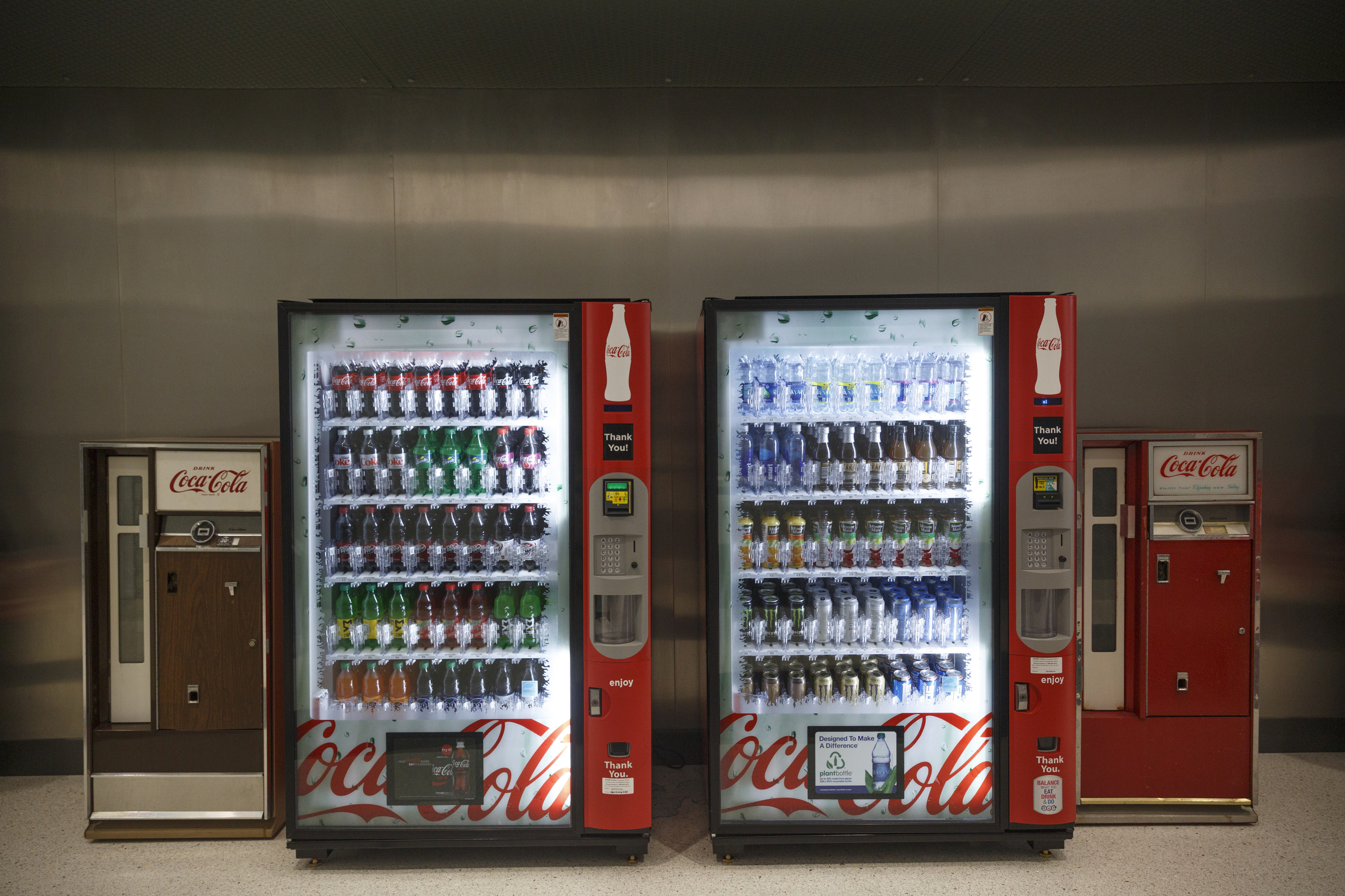 Old Coca-Cola vending machines flank new machines in the new Coca-Cola Bottling Company United divisional headquarters on Sheperd Road on Friday, Feb. 19, 2016, in Chattanooga, Tenn. The $67 million facility is at the site of the old Olan Mills campus.