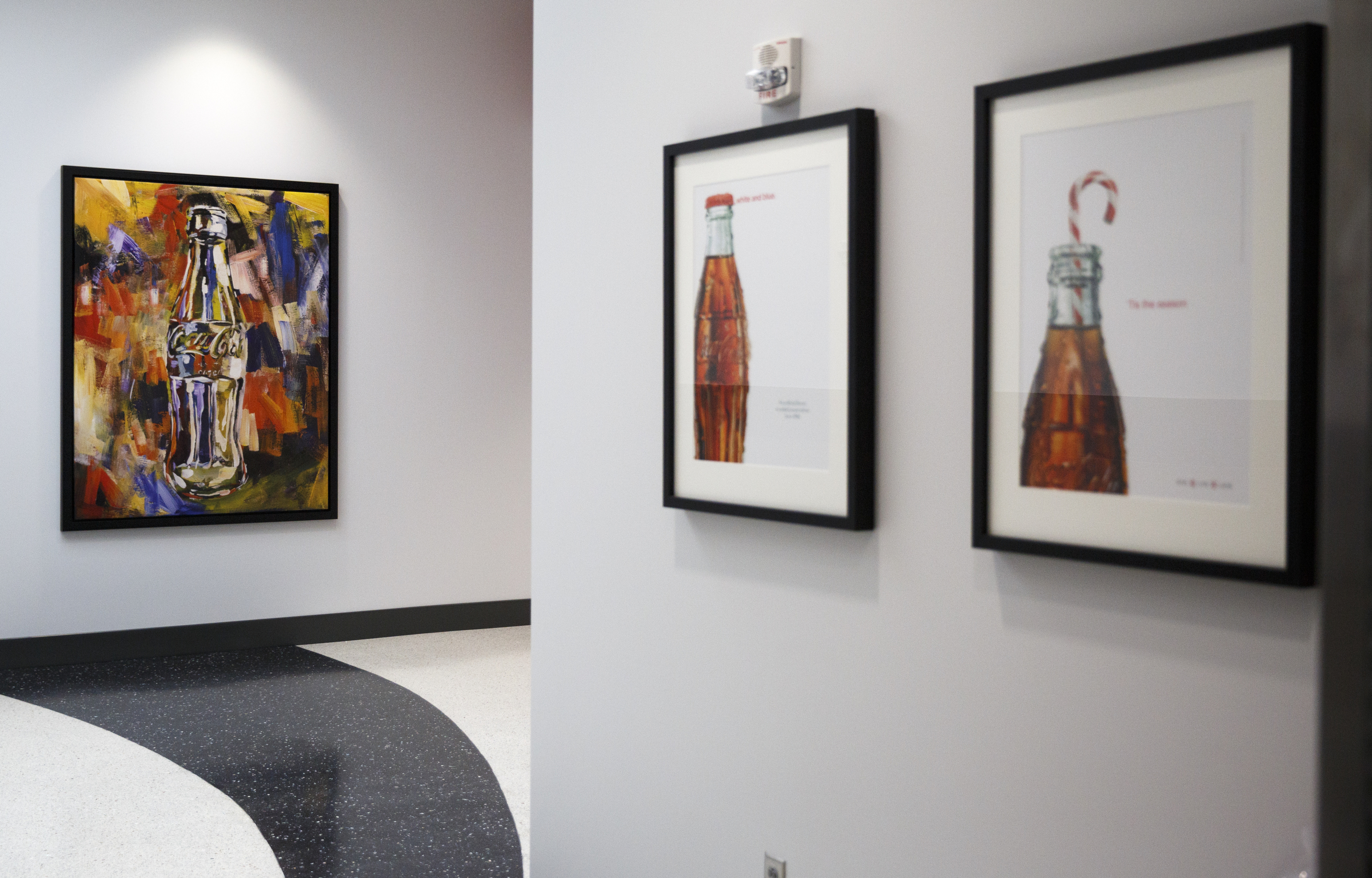 Coca-Cola themed artwork and memorabilia line the walls of the new Coca-Cola Bottling Company United divisional headquarters on Sheperd Road on Friday, Feb. 19, 2016, in Chattanooga, Tenn. The $67 million facility is at the site of the old Olan Mills campus.