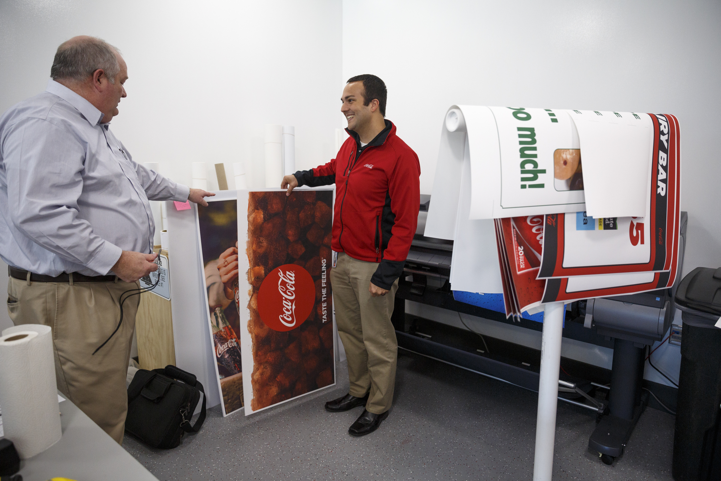 Tennessee Valley division director Darren Hodges, left, talks with print zone manager Jonathan Gomez in their in-house printing center at the new Coca-Cola Bottling Company United divisional headquarters on Sheperd Road on Friday, Feb. 19, 2016, in Chattanooga, Tenn. The $67 million facility is at the site of the old Olan Mills campus.
