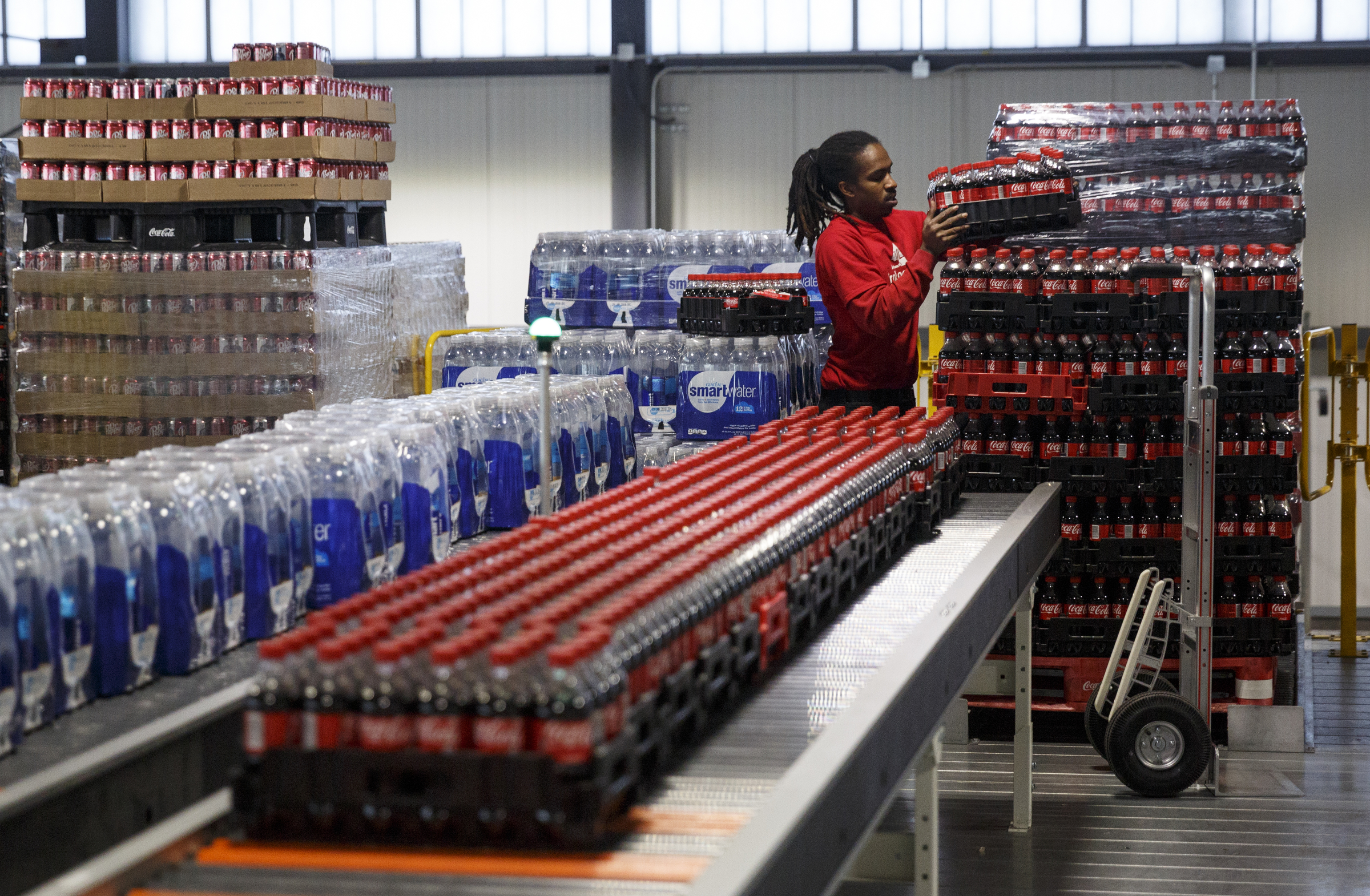 Tarus Earls moves crates of beverages for distribution at the new Coca-Cola Bottling Company United divisional headquarters on Sheperd Road on Friday, Feb. 19, 2016, in Chattanooga, Tenn. The $67 million facility is at the site of the old Olan Mills campus.