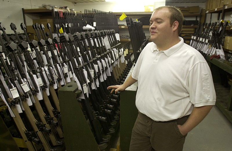 Chris Barrett, a weapons designer and son of Ronnie Barrett, the founder of Barrett Firearms Manufacturing Inc., shows the .50-caliber rifles the company manufactures and which are used by the U.S. military.