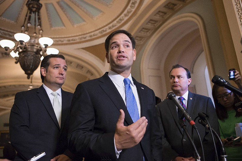 In this Sept. 27, 2013 file photo, Sen. Marco Rubio, R-Fla., center, accompanied by Sen. Ted Cruz, R-Texas, left, and Sen. Mike Lee, R-Utah, speaks during a news conference on Capitol Hill in Washington. Cruz's campaign is spending nearly 10 times as much money as Rubio's in Chattanooga, but Rubio has picked up key GOP endorsements in the state. (AP Photo/J. Scott Applewhite, File)