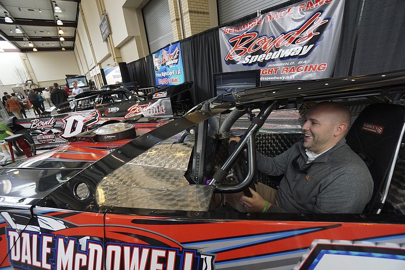 Staff Photo by Dan Henry / The Chattanooga Times Free Press- 2/26/16. Jordan Dent tries out a driving simulator at the Boyds Speedway booth during the annual Tri-State Home Show on Friday, February 26, 2016. 