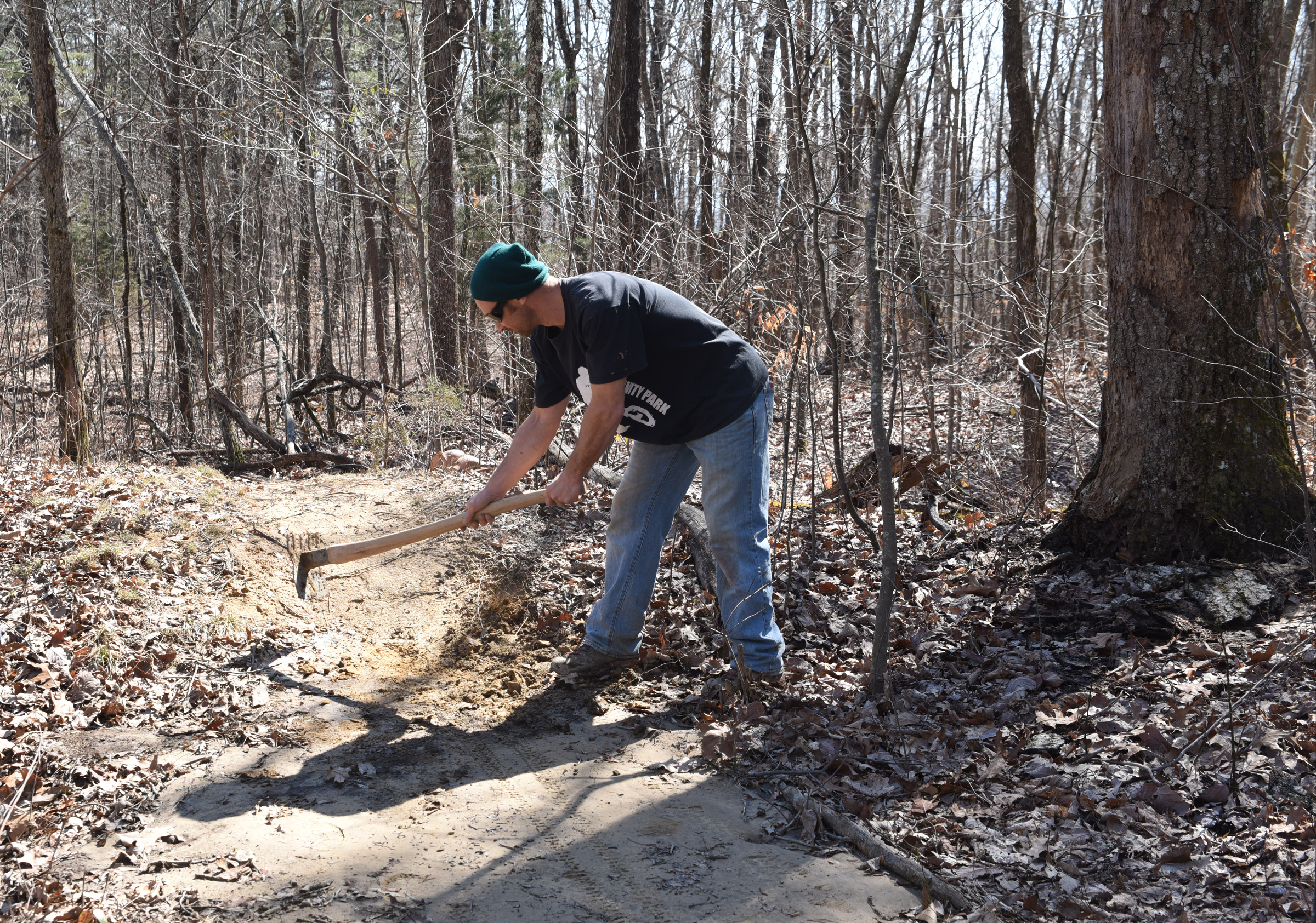 Troy Roberts prepares a place on the trail Friday atop Sequatchie Mountain. The trail drops 1,050-feet in 1.1-miles into Coppinger Cove in Marion County.