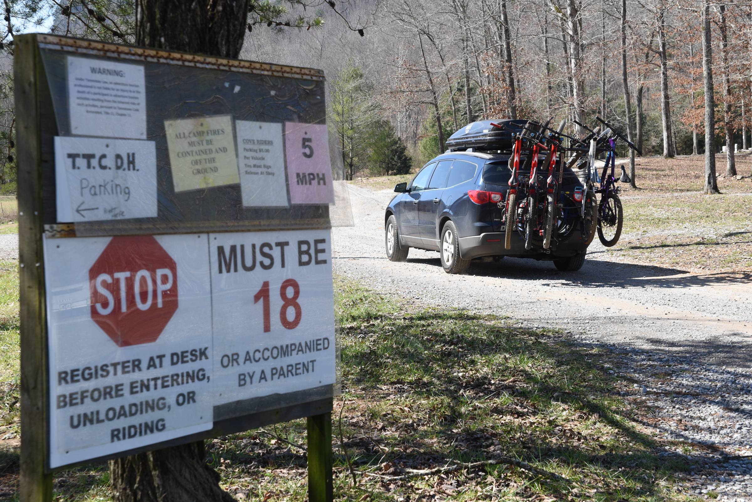 A vehicle laden with several bicycles enters the Trials Training Center property Friday for practice on the downhill course known as The Goat Trail where pro and amateur riders will compete this weekend on Sequatchie Mountain.