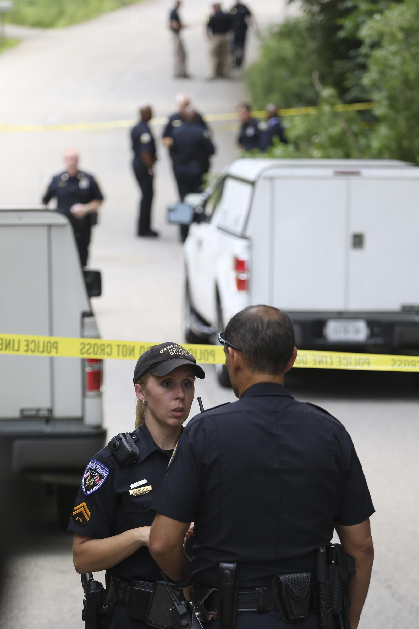 Staff Photo by Dan Henry / The Chattanooga Times Free Press- 6/11/15. Chattanooga Police Department Master Patrolman Jamie Barrow, left, speaks to Chattanooga Police Chief Fred Fletcher as emergency personnel work the scene of a shooting at 3822 Youngstown Road where two four-year-old girls suffered from non-life threatening injuries from a drive by at 1pm on Thursday, June 11, 2015.