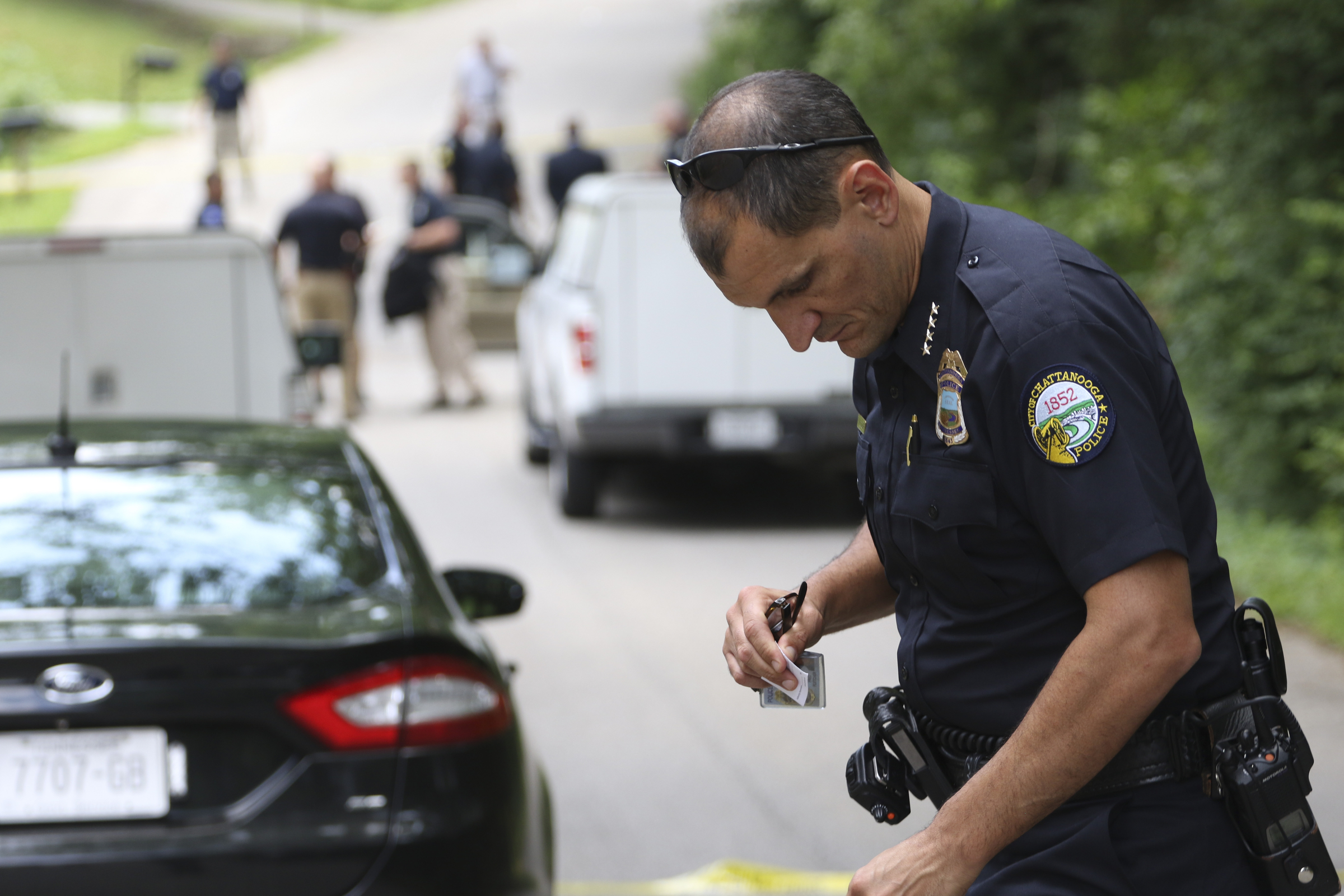 Staff Photo by Dan Henry / The Chattanooga Times Free Press- 6/11/15. Chattanooga Police Chief Fred Fletcher places a marker on a piece of evidence as emergency personnel work the scene of a shooting at 3822 Youngstown Road where two four-year-old girls suffered from non-life threatening injuries from a drive by at 1pm on Thursday, June 11, 2015.