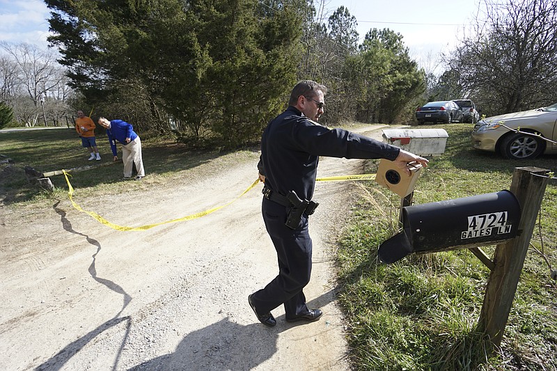 Staff Photo by Dan Henry / The Chattanooga Times Free Press- 2/29/16. Hamilton County Sheriff's Office Sgt. Adams, strings up crime scene tape as the HCSO investigate the shooting death of a 3-year-old boy outside the home at 4724 Gates Lane. The boy, whose name has not been released, was taken to a local hospital on Monday, February 29, 2016, where he was pronounced dead, according to the sheriff's office.