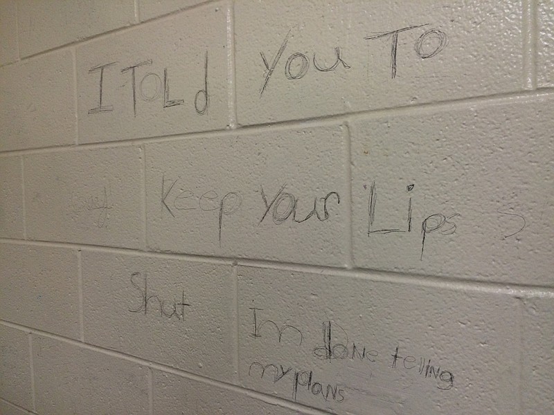 A message scrawled on the wall of the boys bathroom purports to be a threat against Ooltewah High School. 