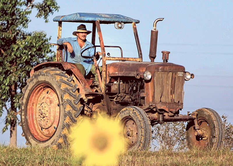 A farmer drives his tractor in Pinar del Rio, Cuba. The Obama administration has approved the first U.S. factory in Cuba in more than half a century, allowing a pair of former software engineers to build a plant assembling as many as 1,000 small tractors a year.
