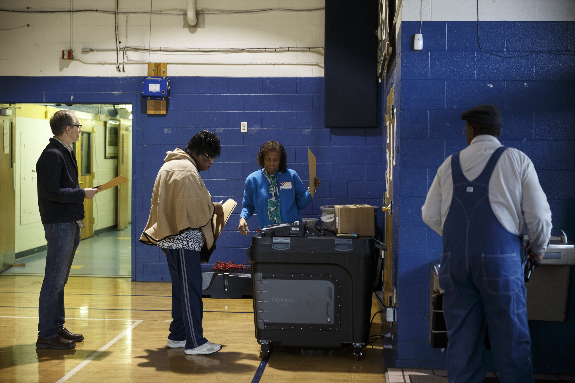 Poll worker Ethel Cox, center, helps Mattie Fuquay place her ballot in a voting machine flanked by Sam Moore, left, and Lieutenant Fuquay, right, during the Super Tuesday primary election at the Bethlehem Center polling location on Tuesday, March 1, 2016, in Chattanooga, Tenn.