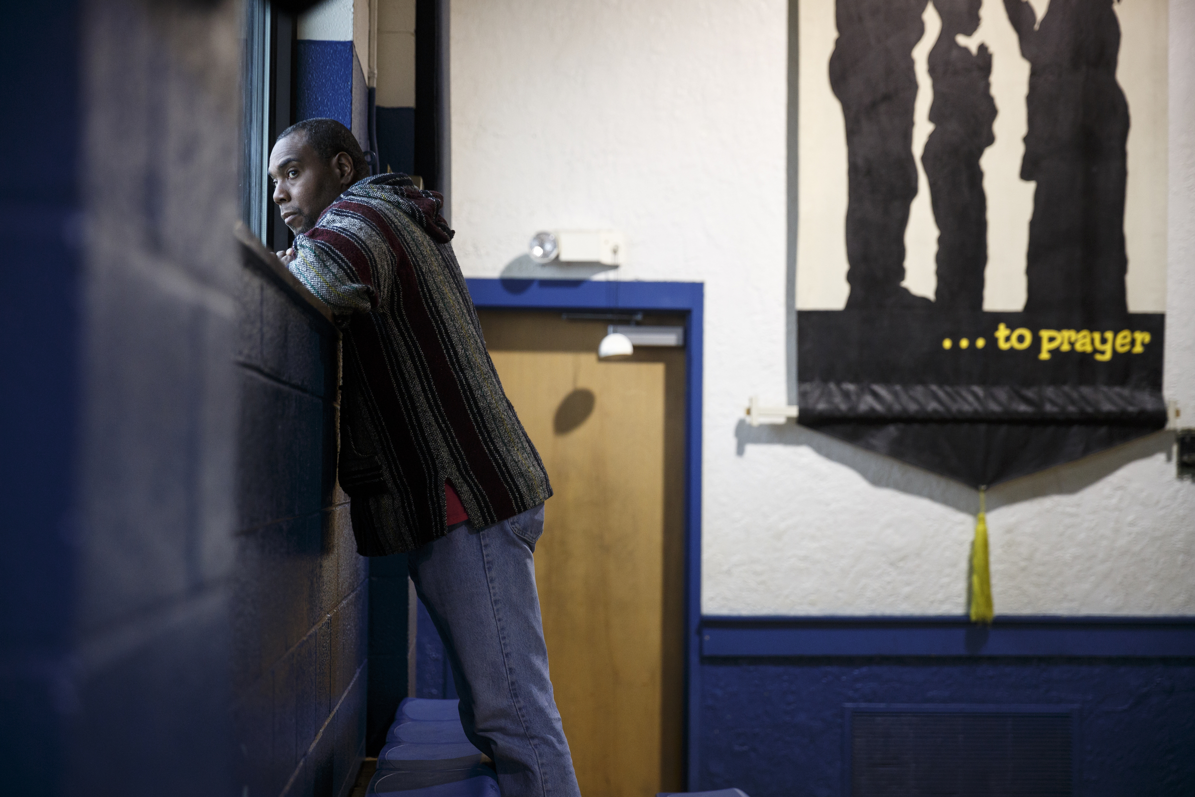 Michael Davis looks out a window at rain during voting in the Super Tuesday primary election at the Bethlehem Center polling location on Tuesday, March 1, 2016, in Chattanooga, Tenn.