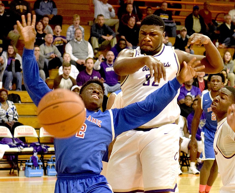 Central's McClendon Curtis (32) blocks the shot of Red Bank's Will Davis (2).  The Central Purple Pounders faced the Red Bank Lions in the semi-finals of the Region 3-AA basketball tournament at East Ridge High School Tuesday March 1, 2016.