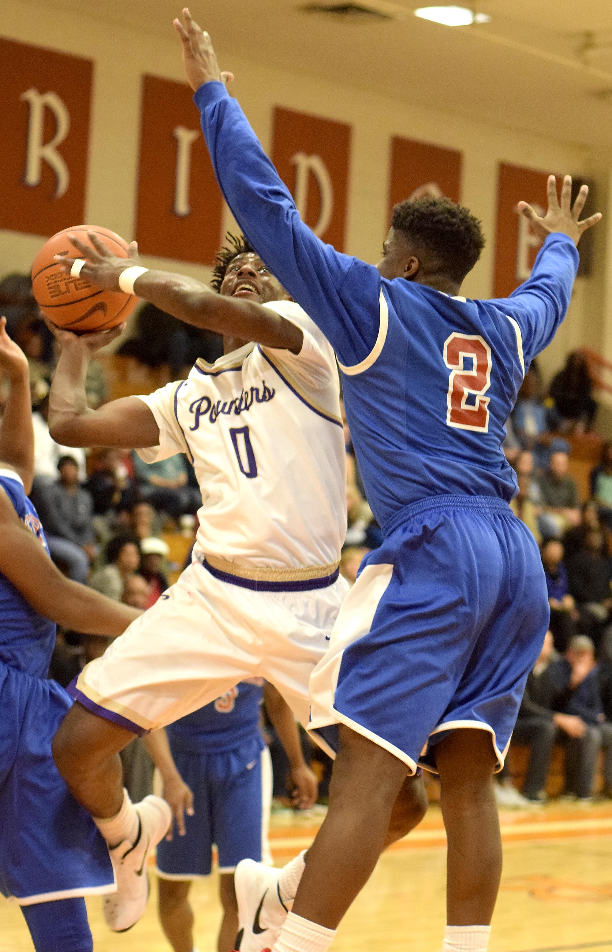 Central's Emmanuel Lane (0) puts up a shot past Red Bank's Will Davis (2). The Central Purple Pounders faced the Red Bank Lions in the semi-finals of the Region 3-AA basketball tournament at East Ridge High School Tuesday March 1, 2016.