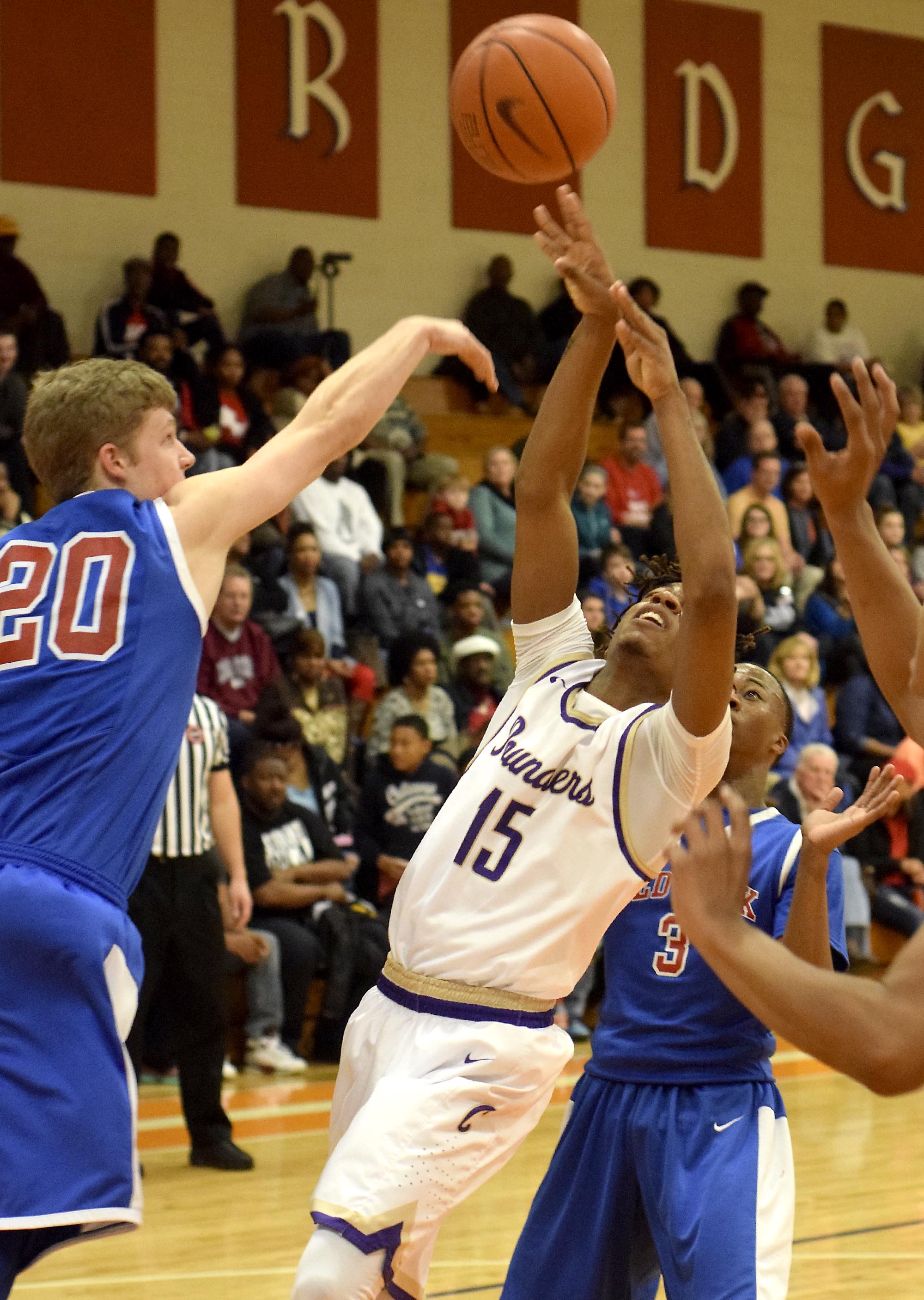Red Bank's Will Thomas (20) blocks the shot of Central's Rodney Benford (15). The Central Purple Pounders faced the Red Bank Lions in the semi-finals of the Region 3-AA basketball tournament at East Ridge High School Tuesday March 1, 2016.