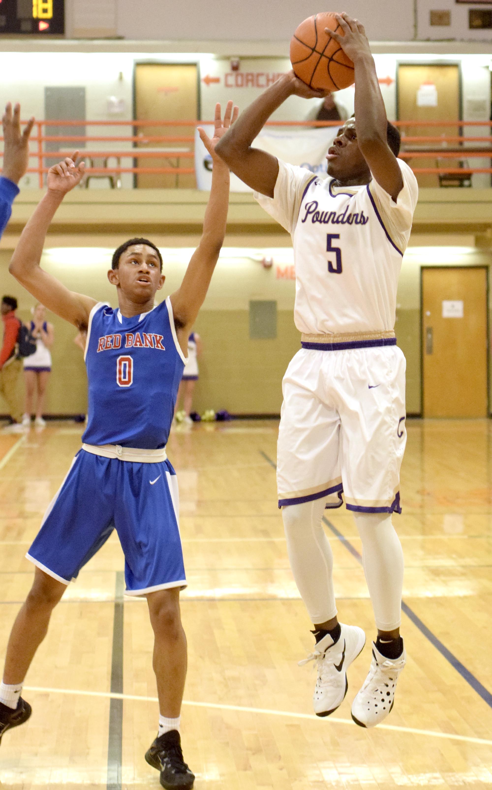 Central's Terron Hayes (5) puts up a jump shot over the defense of Red Bank's Kolbi Suttles (0). The Central Purple Pounders faced the Red Bank Lions in the semi-finals of the Region 3-AA basketball tournament at East Ridge High School Tuesday March 1, 2016.