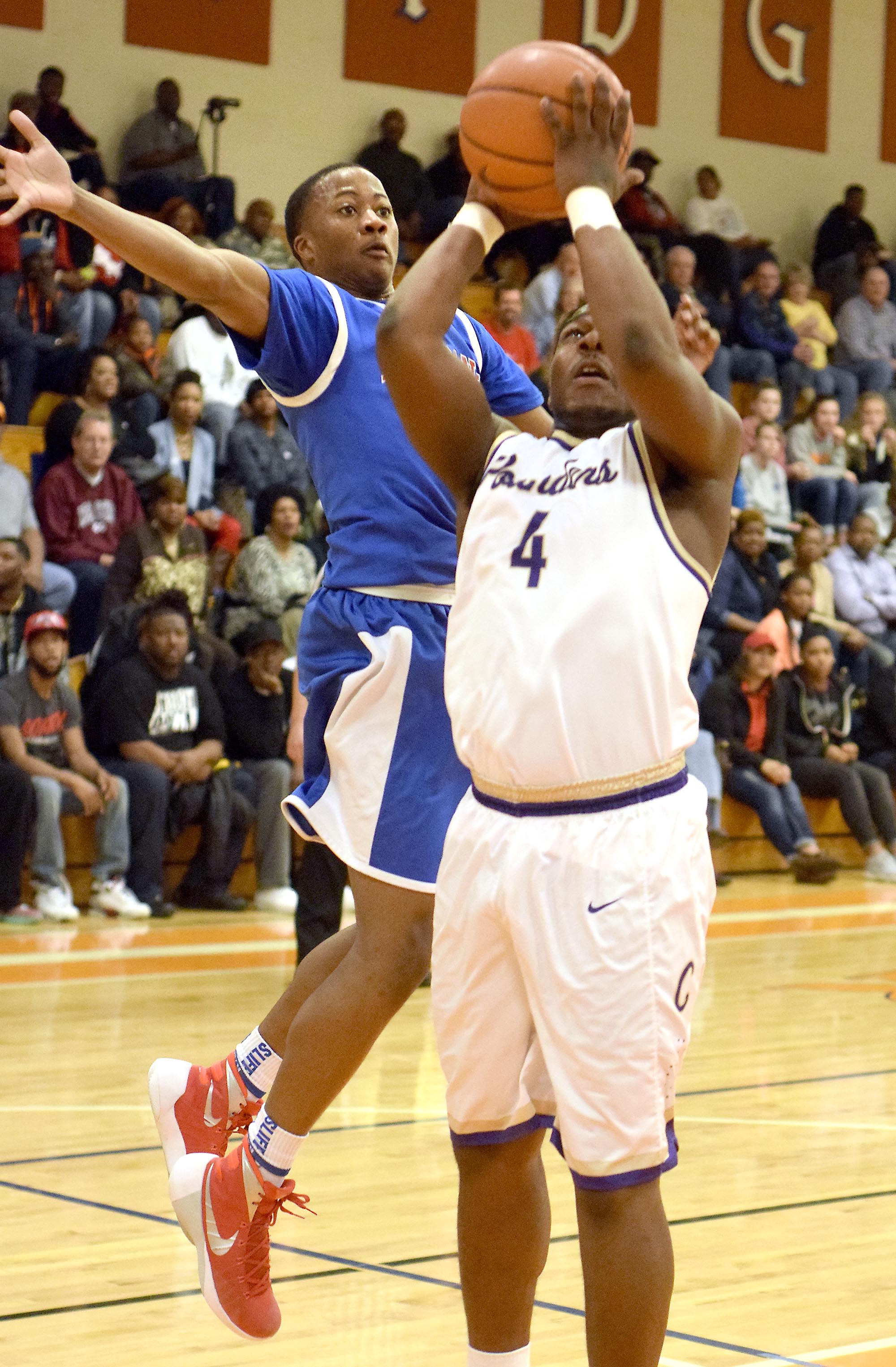 Red Bank's Malik McConnell readies to block the shot of Central's Devin Swafford (4). The Central Purple Pounders faced the Red Bank Lions in the semi-finals of the Region 3-AA basketball tournament at East Ridge High School Tuesday March 1, 2016.