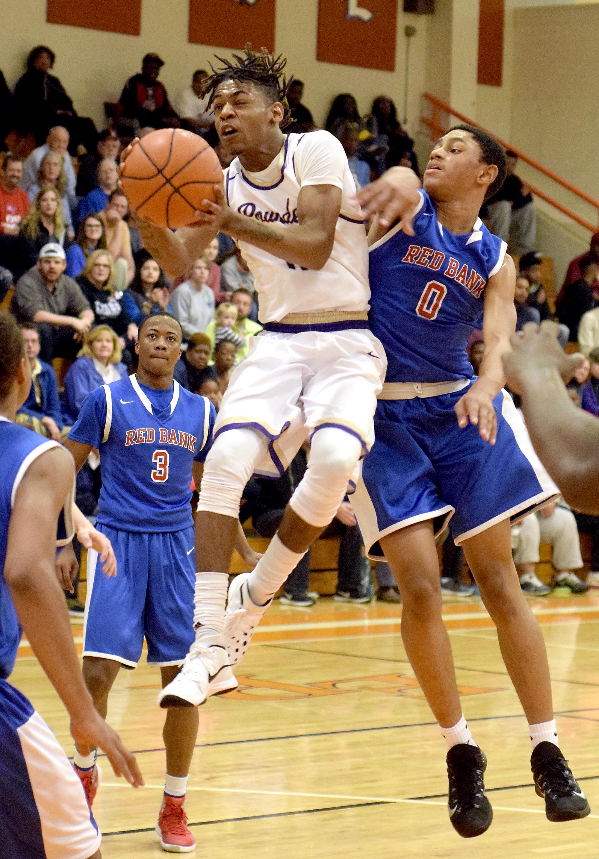 Central's Rodney Benford goes up for a shot while Red Bank's Kolbi Suttles (0) defends. The Central Purple Pounders faced the Red Bank Lions in the semi-finals of the Region 3-AA basketball tournament at East Ridge High School Tuesday March 1, 2016.