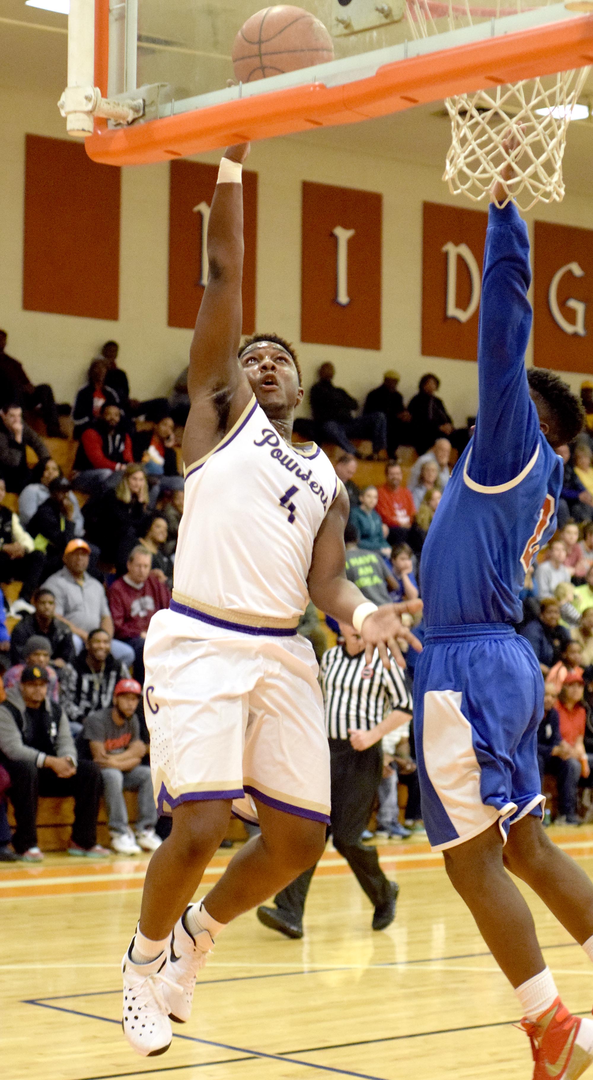 Central's Devin Swafford (4) scores on a layup while Red Bank's Will Davis (2) defends. The Central Purple Pounders faced the Red Bank Lions in the semi-finals of the Region 3-AA basketball tournament at East Ridge High School Tuesday March 1, 2016.