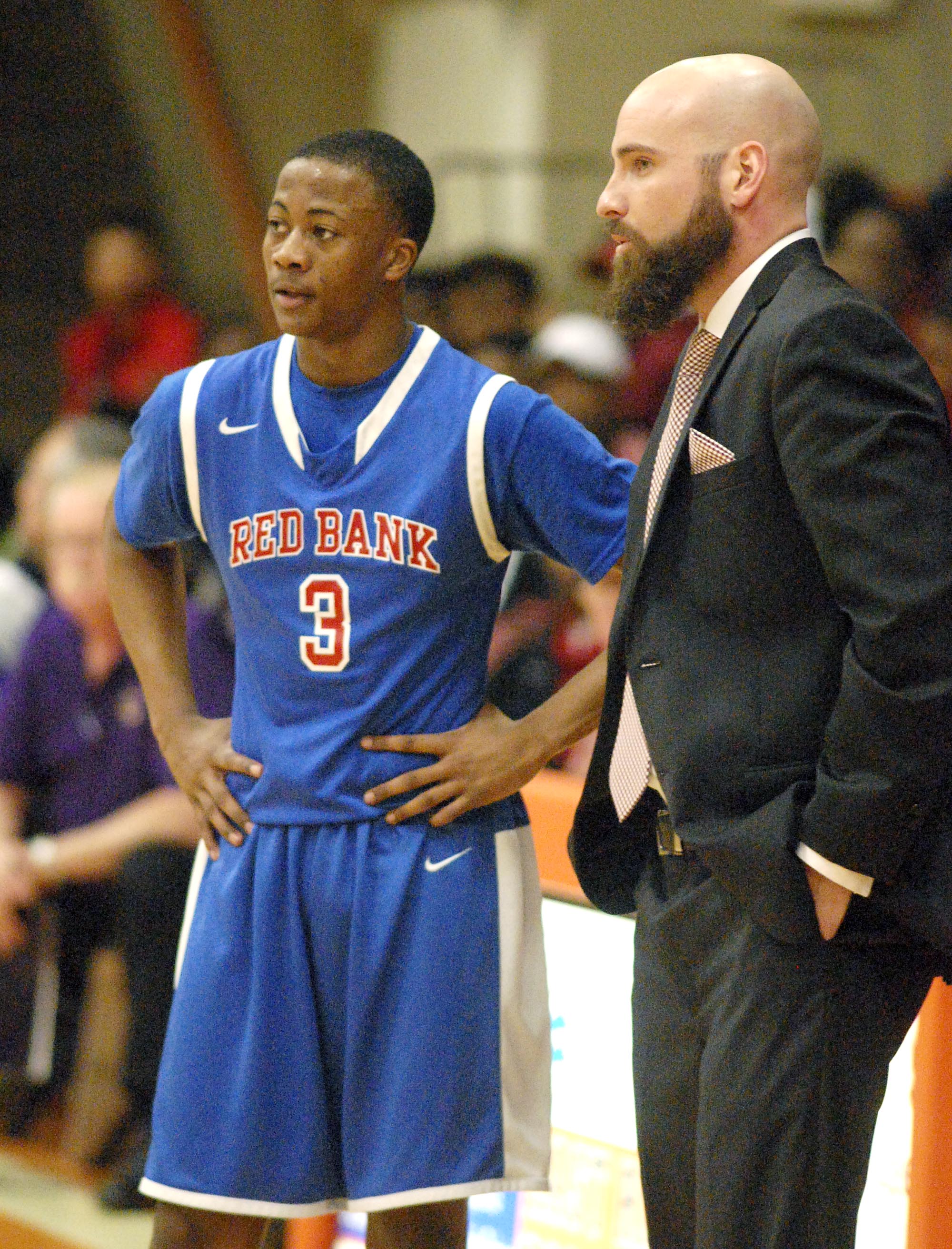 Red Bank head coch Rick Fike (right) discusses the game with Malik McConnell (3). The Central Purple Pounders faced the Red Bank Lions in the semi-finals of the Region 3-AA basketball tournament at East Ridge High School Tuesday March 1, 2016.