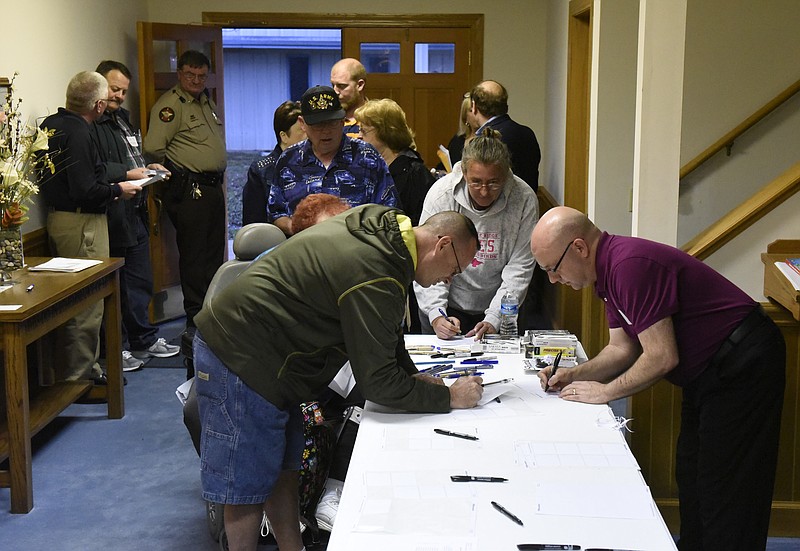 Jim Hill, right, makes name tags for attendees as they enter a community meeting at the Mission Glen Baptist Church on Tuesday, Mar. 1, 2016, near Rossville, Ga. The meeting was organized by David Roden in hopes to increase community involvement to address a number of issues in the Rossville and North Walker County areas. 