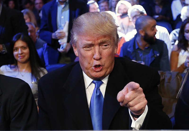 FILE - In this Oct. 17, 2015 file photo, Republican presidential candidate Donald Trump watches as Tureano Johnson fights Eamonn O'Kane in an IBF middleweight bout at Madison Square Garden in New York. The U.S. Secret Service says the top two GOP presidential hopefuls have requested protection from the taxpayer-funded agency. The agency says billionaire real estate developer Donald Trump and retired neurosurgeon Ben Carson have requested Secret Service protection. But they would not receive it until Homeland Security Secretary Jeh Johnson consults with five senior members of Congress.  (AP Photo/Rich Schultz, File)