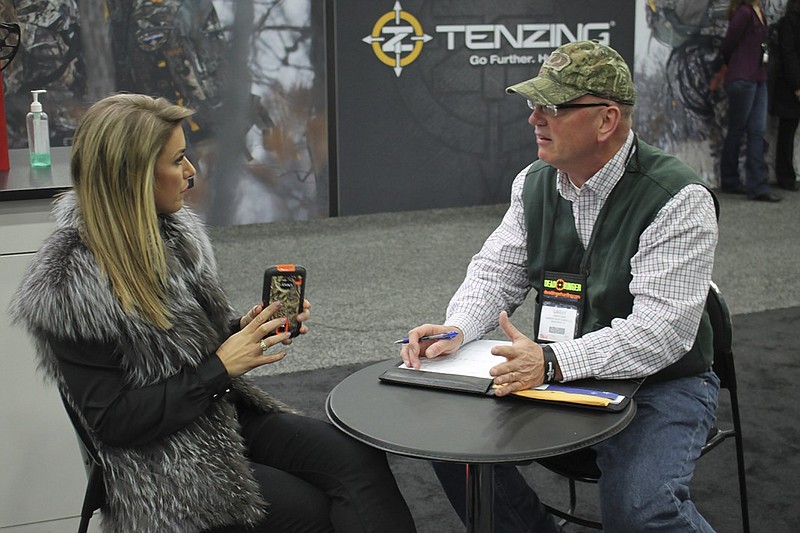 Outdoors television host Eva Shockey talks with The Trail Less Traveled columnist Larry Case during the Archery Trade Association's annual trade show in January in Louisville, Ky.