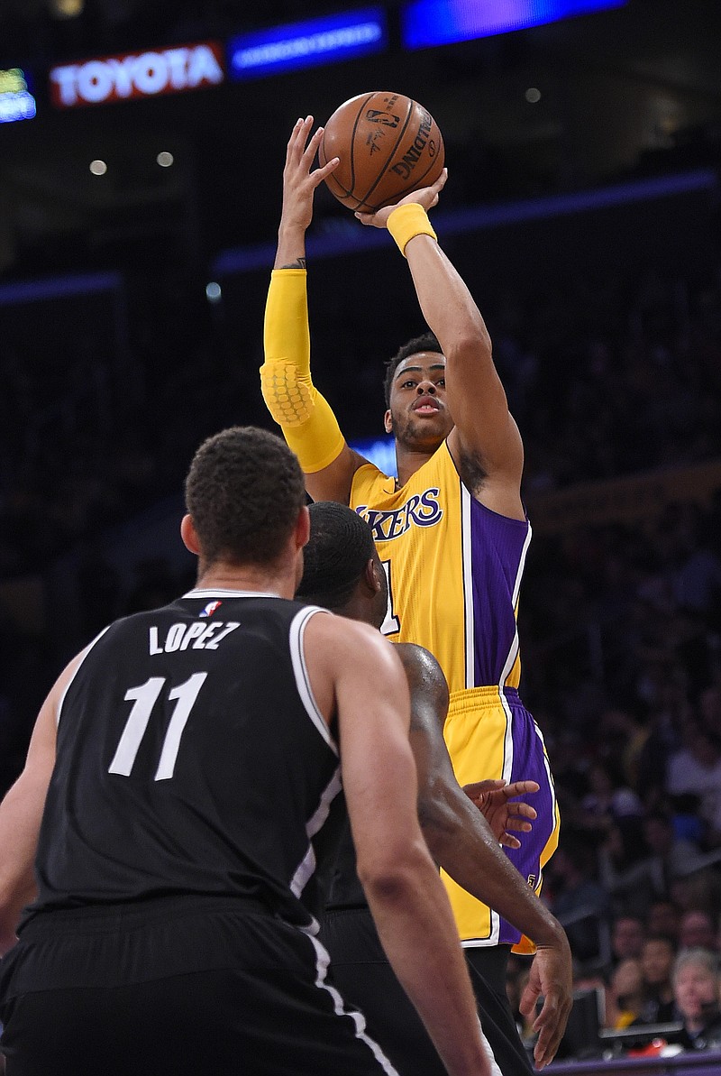
              Los Angeles Lakers guard D'Angelo Russell, right, shoots as Brooklyn Nets center Brook Lopez, left, and guard Donald Sloan defend during the first half of an NBA basketball game Tuesday, March 1, 2016, in Los Angeles. (AP Photo/Mark J. Terrill)
            