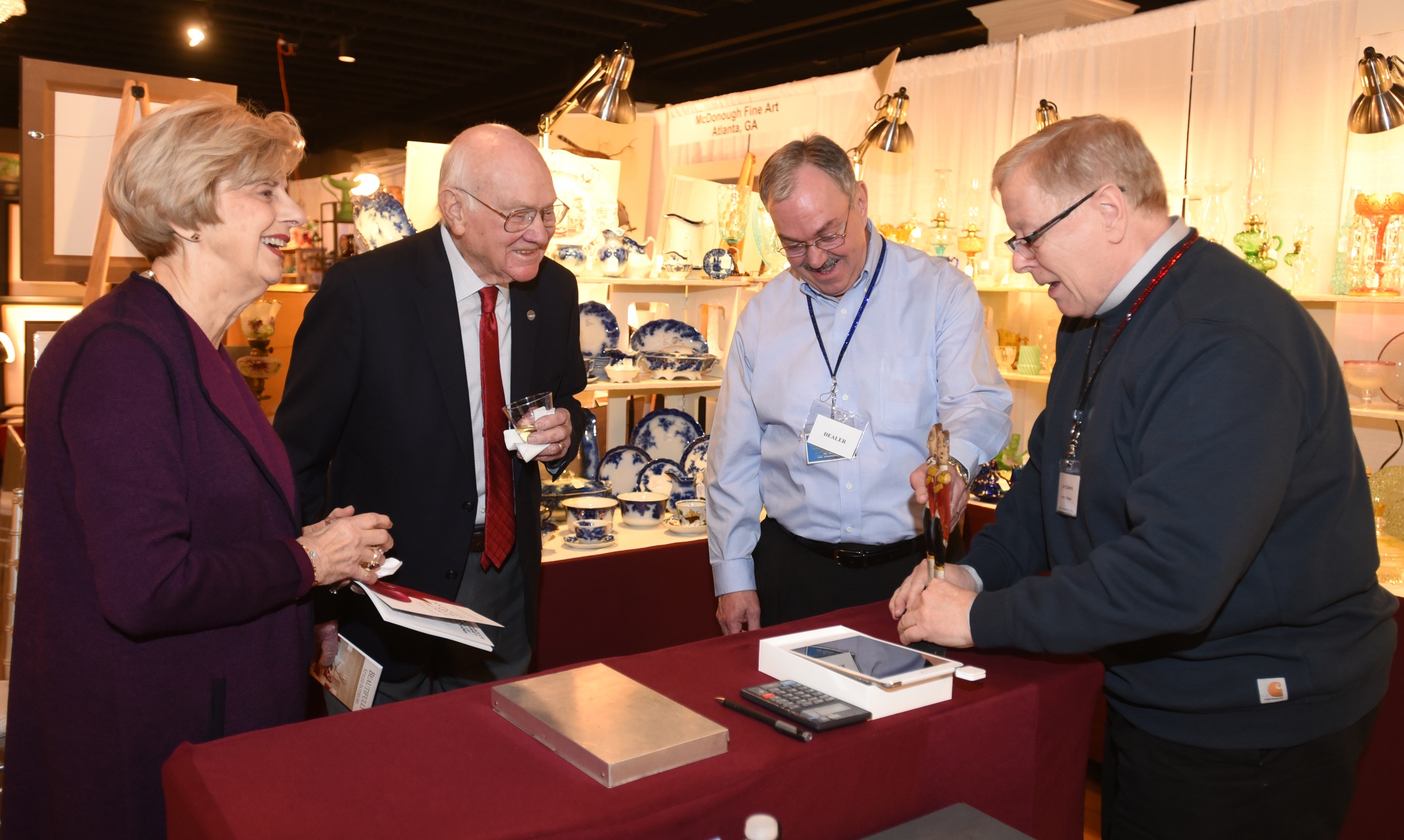 Mary Ann Stewart and Jim Bouldin, left, chat with Houston Antiques show vendors Jerry Laitinen and Jerry Easteria of Jerrys' Antiques in Davenport, Iowa.