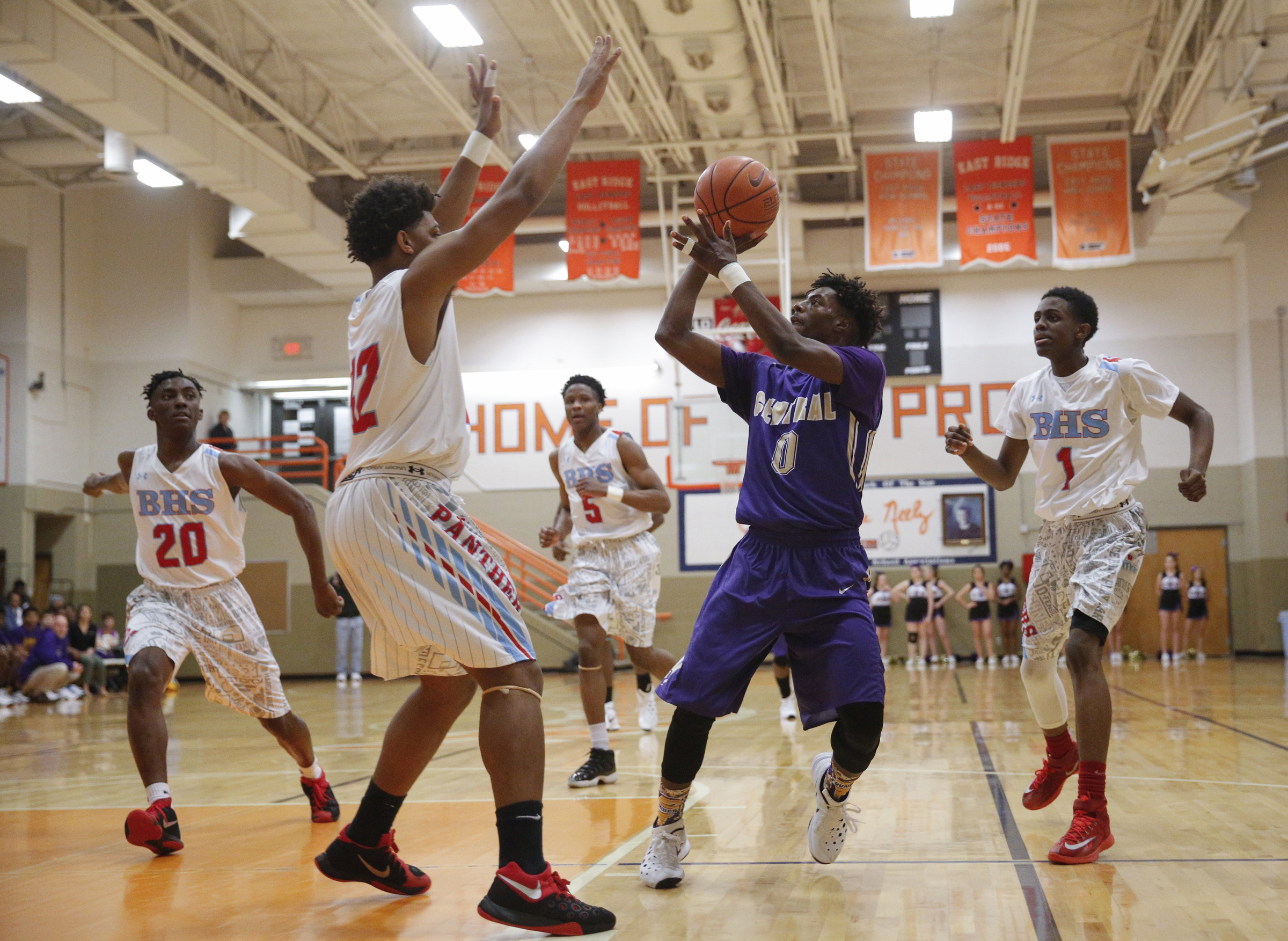 Central's Emmanuel Lane (0) shoots between Brainerd's Vesta Melvin, Jr., (12) during their Region 3-AA boys' basketball tournament championship game at East Ridge High School on Thursday, March 3, 2016, in East Ridge, Tenn.