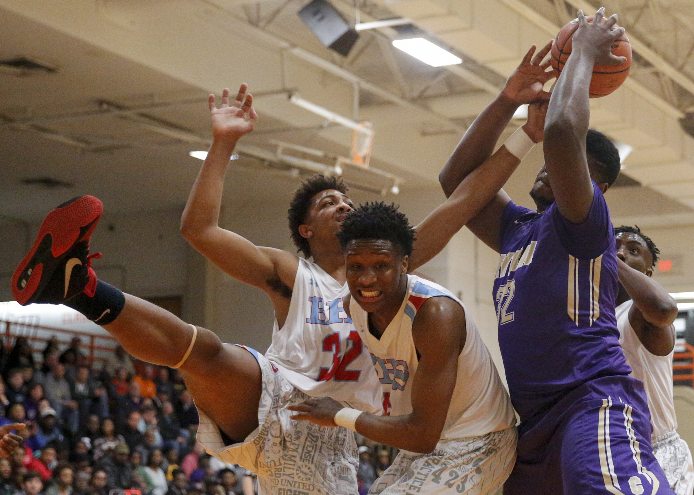 Central's McClendon Curtis, right, rebounds the ball over Brainerd's Jessie Walker (32) and Dajuonta Ross during their Region 3-AA boys' basketball tournament championship game at East Ridge High School on Thursday, March 3, 2016, in East Ridge, Tenn.